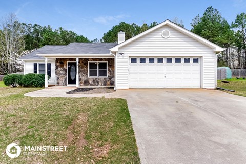 a white house with a driveway and a white garage door