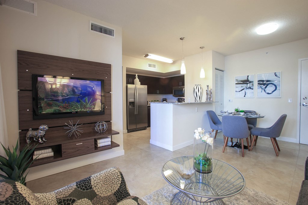 a living room with a tv and a table with chairs