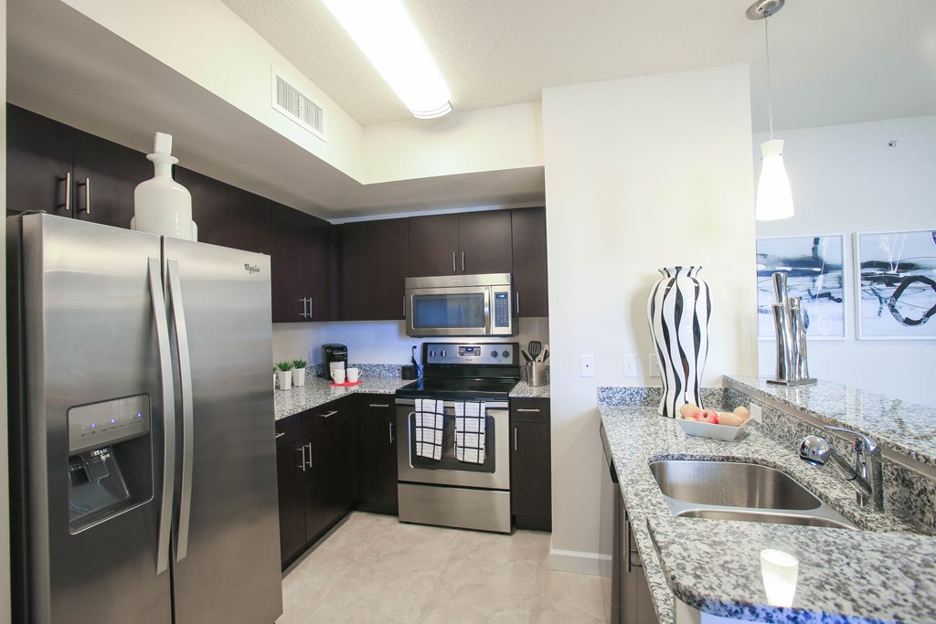 a kitchen with stainless steel appliances and granite counter tops