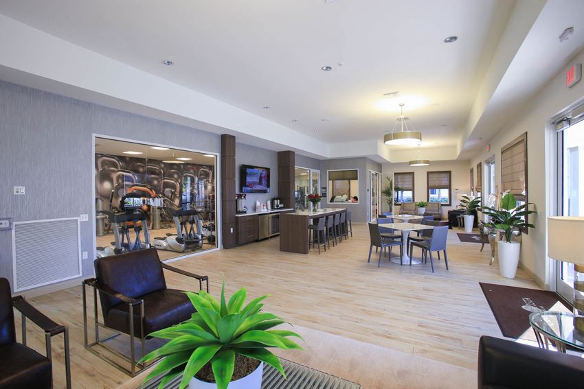 a lobby of a building with tables and chairs