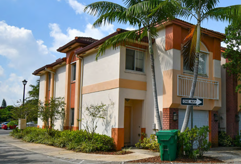 a building with a palm tree in front of it