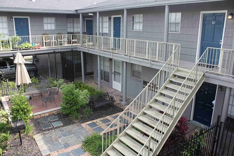 an aerial view of a building with stairs and a courtyard