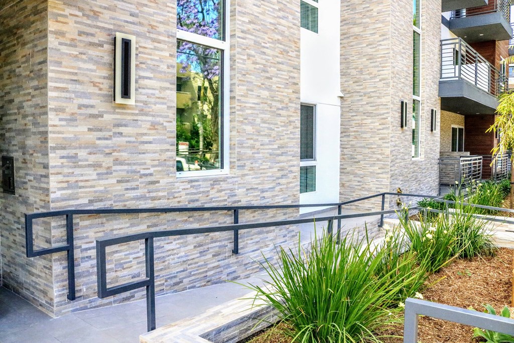 an apartment building with stairs and a glass window