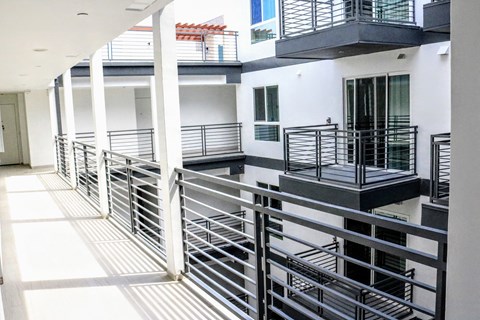 a view of a balcony of a building with metal railing