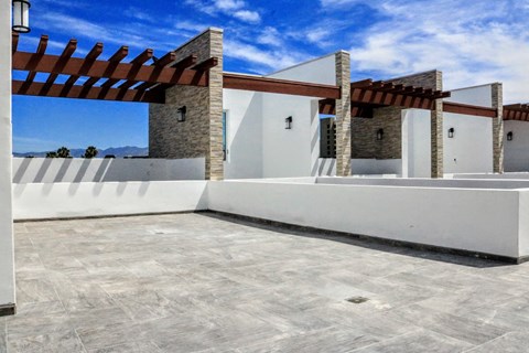 a house with white walls and a patio