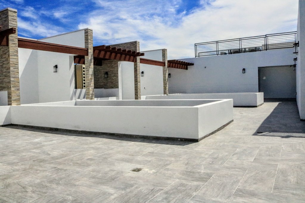 a view of the courtyard of a new home with white walls and a patio