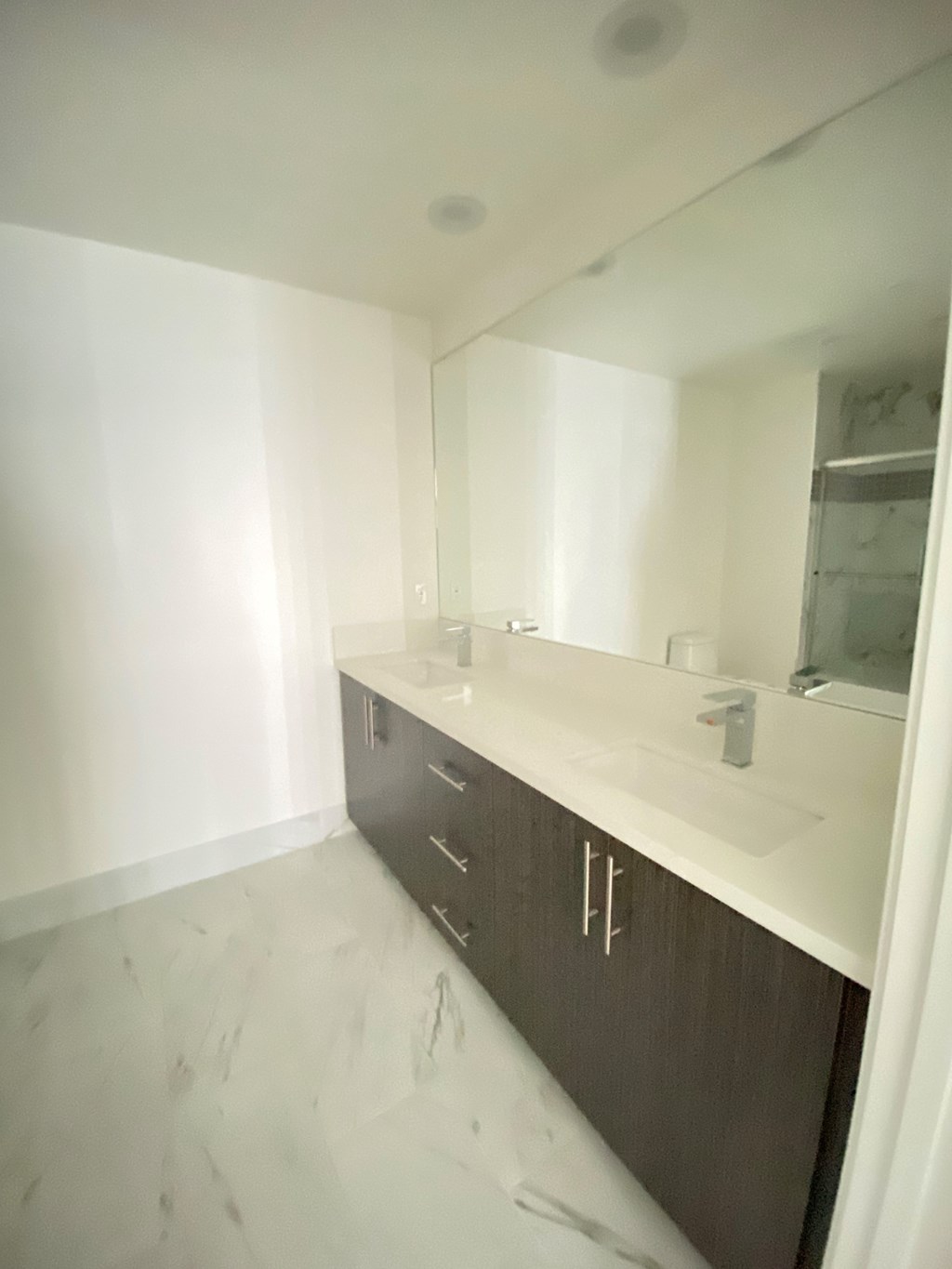 an empty bathroom with a sink and a mirror