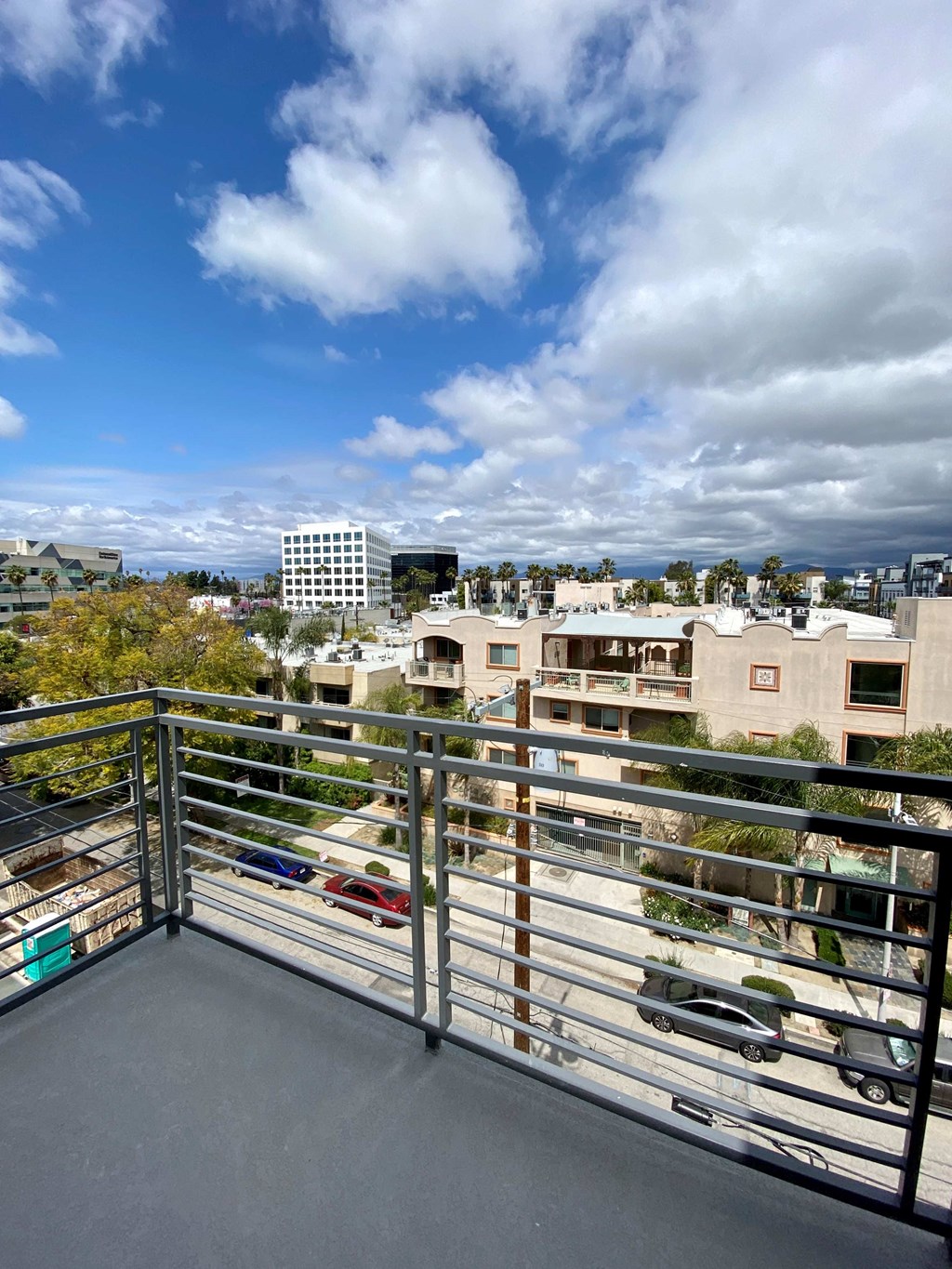 the view of the city from the balcony of a condo