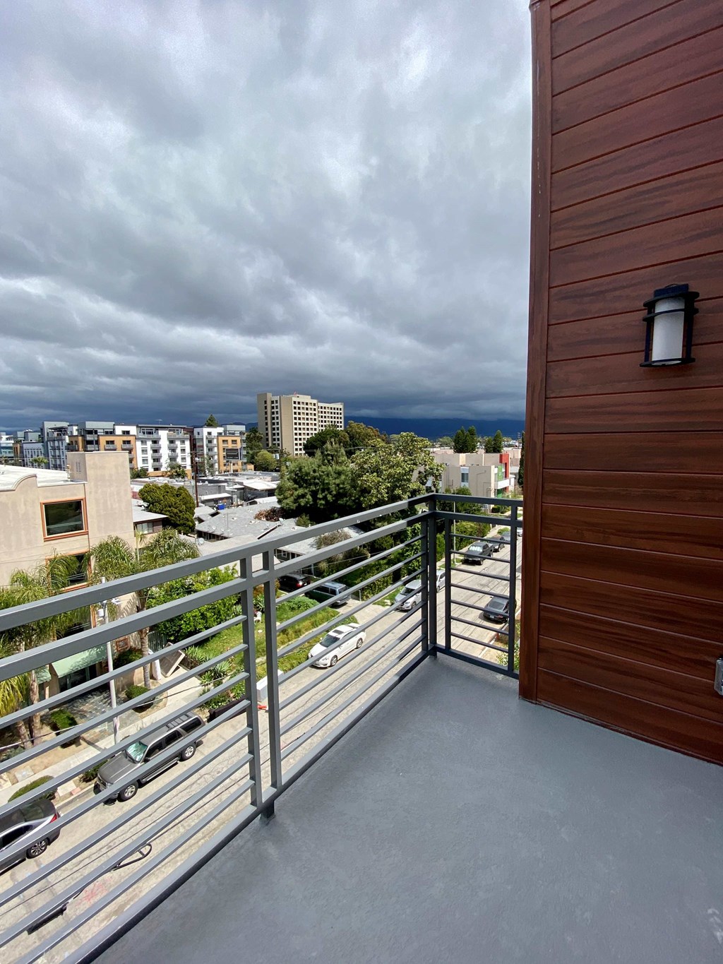 a balcony with a view of the city and the ocean
