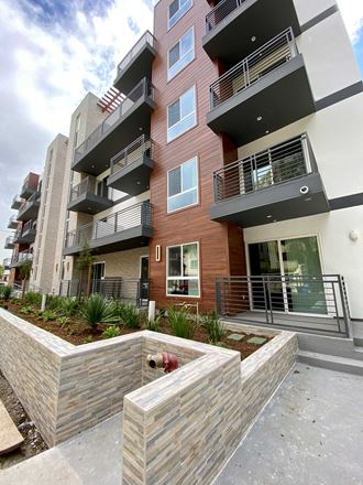 an apartment building with a courtyard in front of it