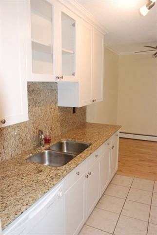 A kitchen with a sink and cabinets.