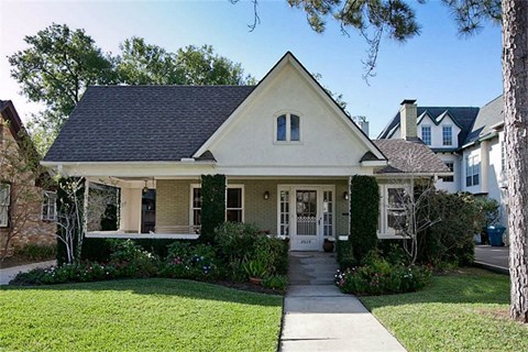 a small house with a sidewalk in front of it