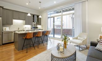 Spacious kitchen and living area with patio view | Monroe Aberdeen Place