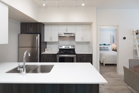 a kitchen with a sink and a refrigerator