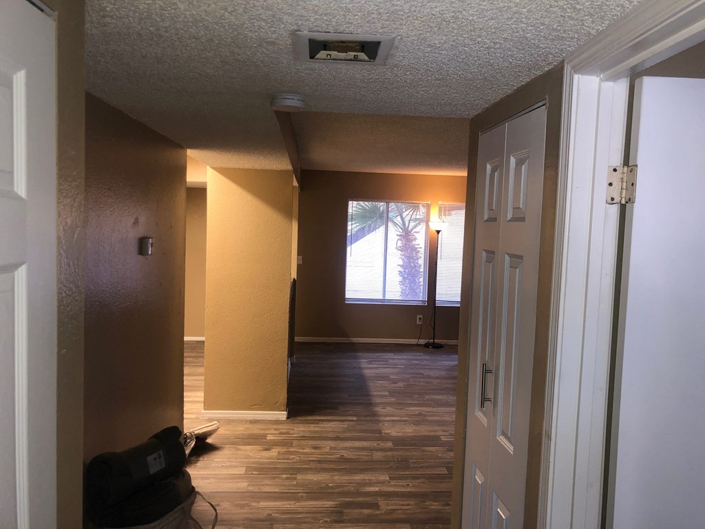 a view of a living room from the hallway with the door open