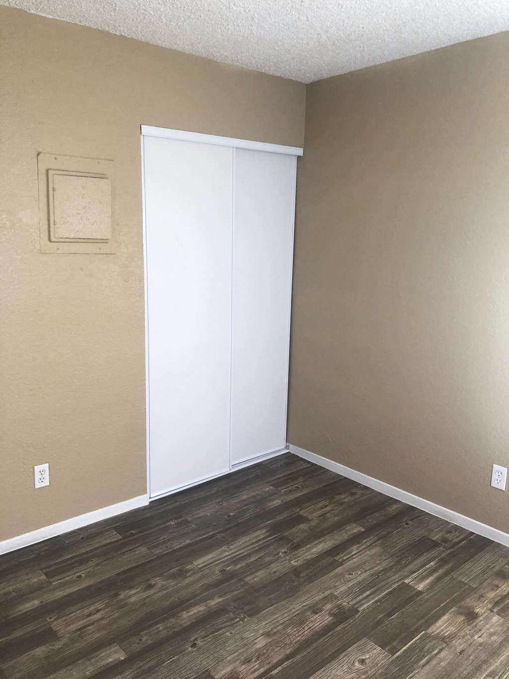 a room with a closet and a hard wood floor