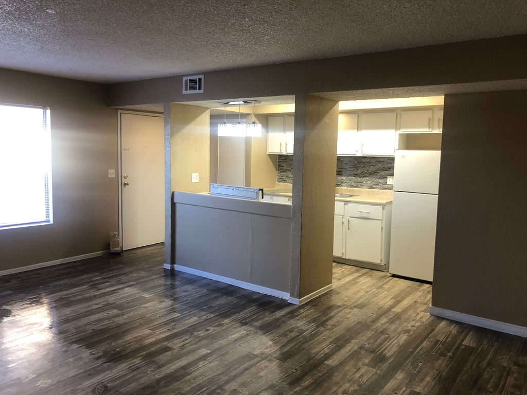 a view of a kitchen and living room with a hard wood floor