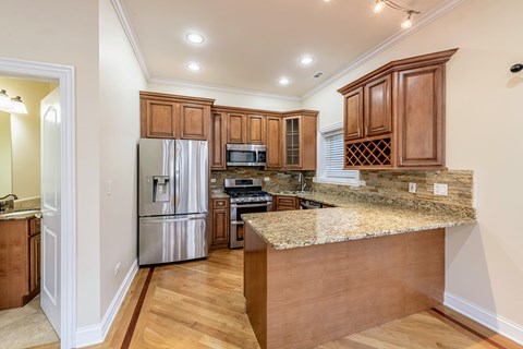 A kitchen with wooden cabinets and granite countertops.