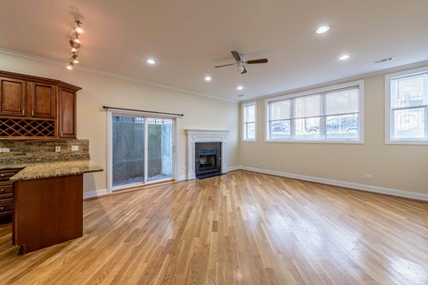 A spacious living room with a fireplace and hardwood floors.