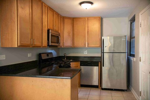 a kitchen with stainless steel appliances and wooden cabinets