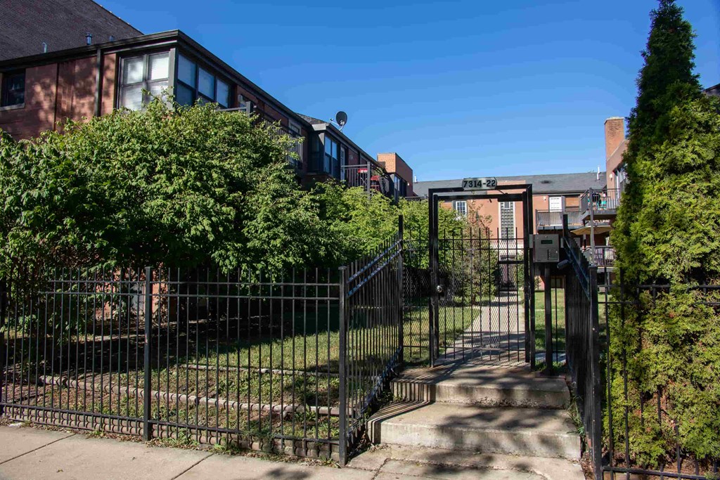 a gate with a fence in front of a house
