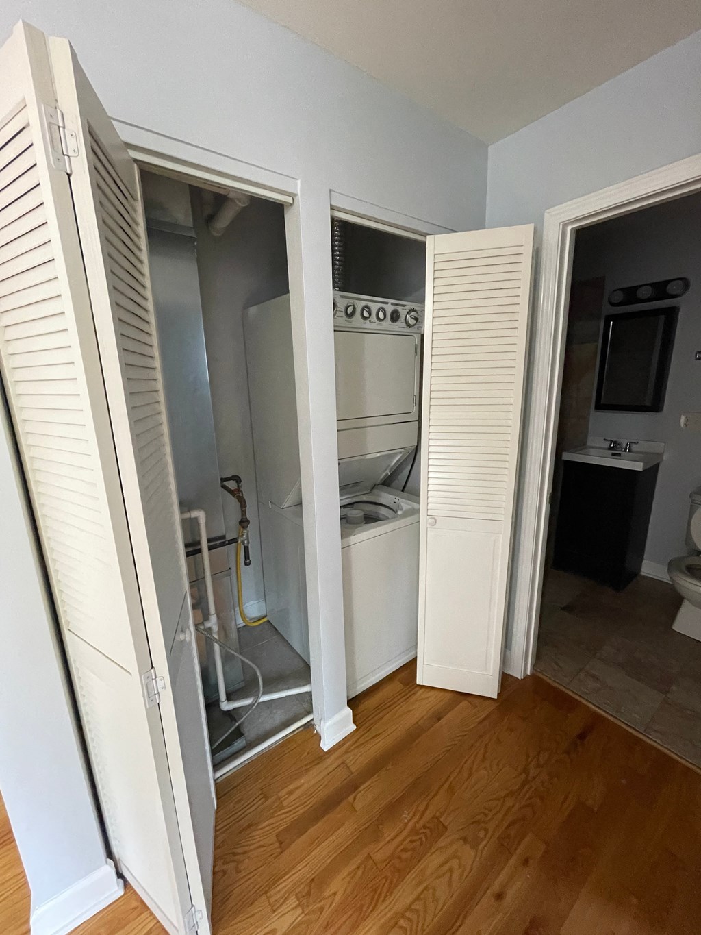 a small room with a closet and a toilet and a sink