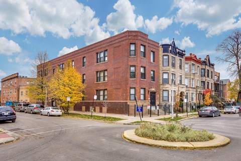 a red brick building on the corner of a city street