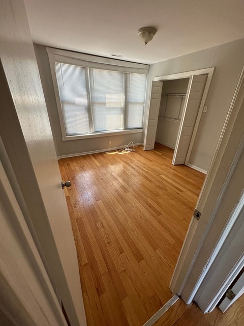 a room with a hard wood floor and a window