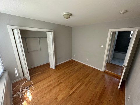 a living room with a hard wood floor and a closet