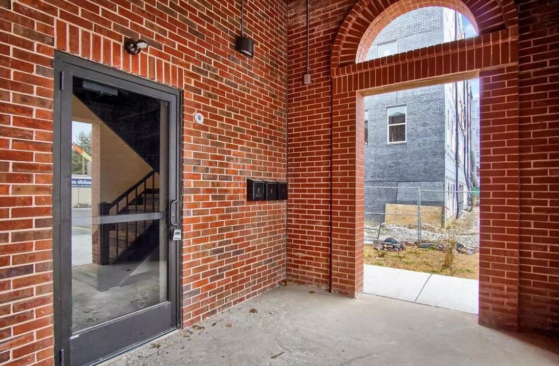 the entrance to a brick building with a glass door