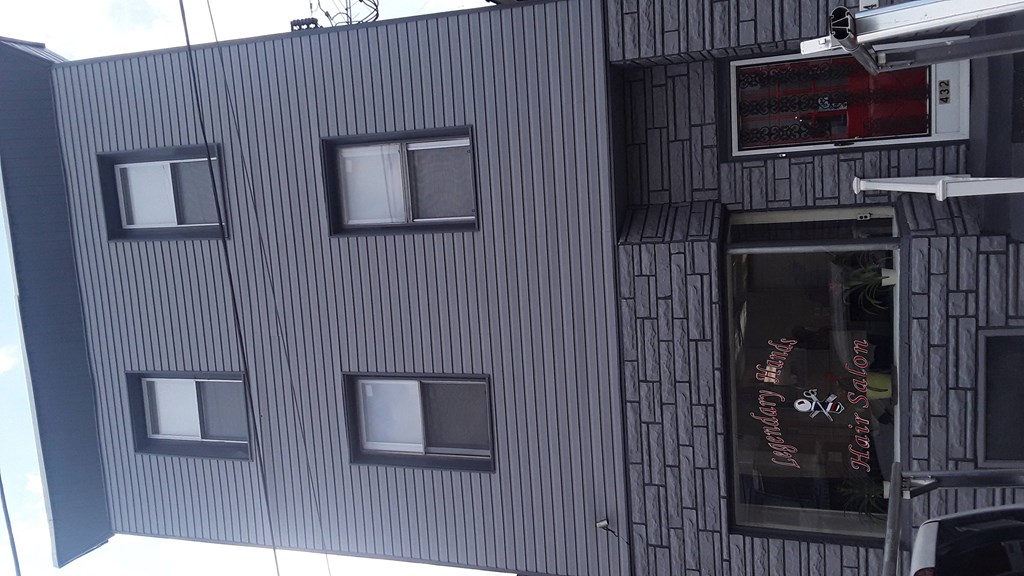 the side of a building with windows and a window shop