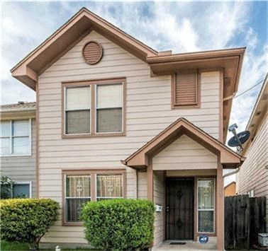 A house with a brown roof and a black door.