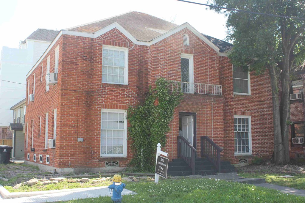 a fire hydrant in front of a brick house