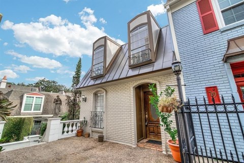 the front of a house with a fence and a door