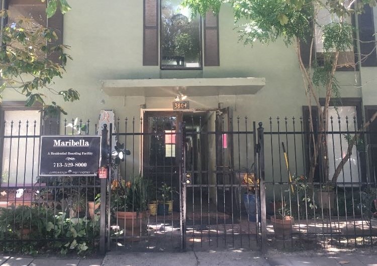 a building with a fence and a gate in front of it