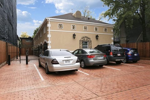 a parking lot with cars in front of a building