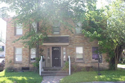 an old brick house with a black door