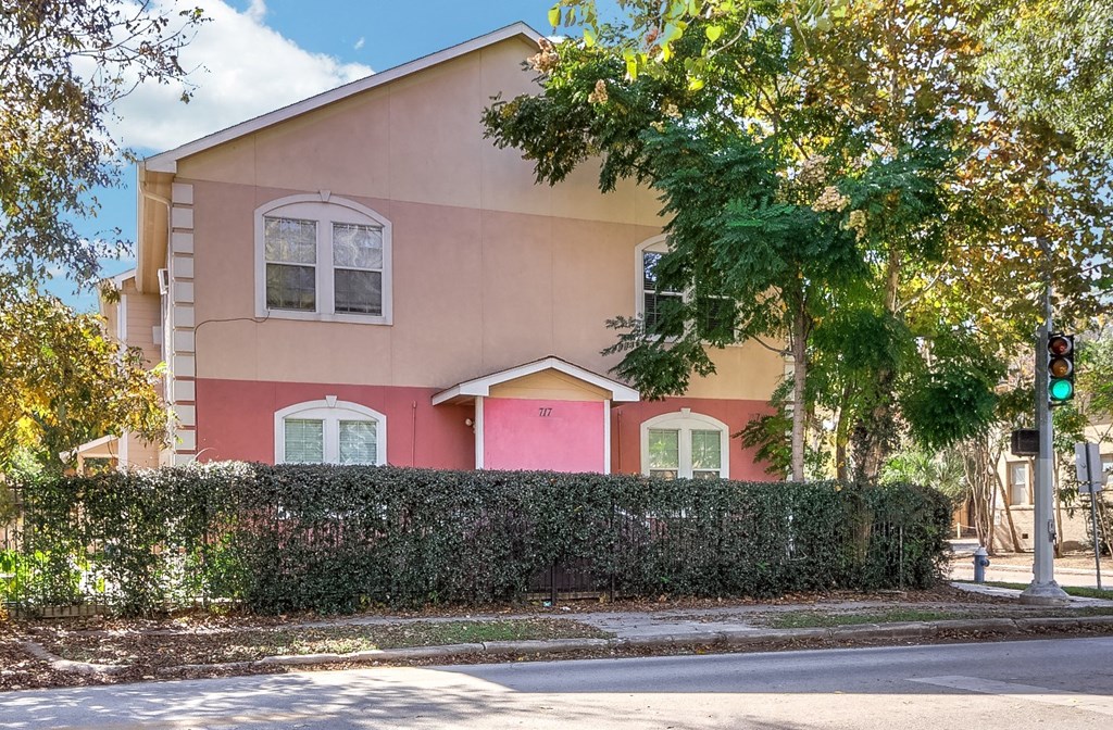 a pink house with a traffic light in front of it