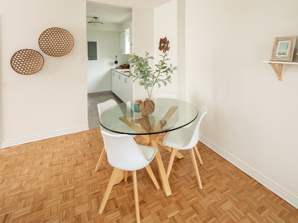 a dining room with a glass table and white chairs