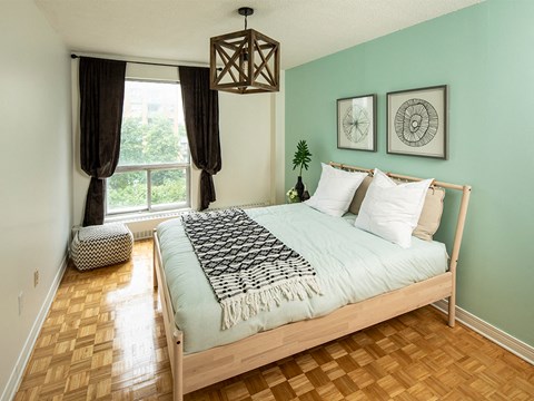 a bedroom with a bed and a window
