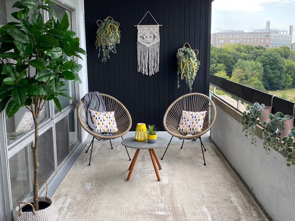 a balcony with two chairs and a table