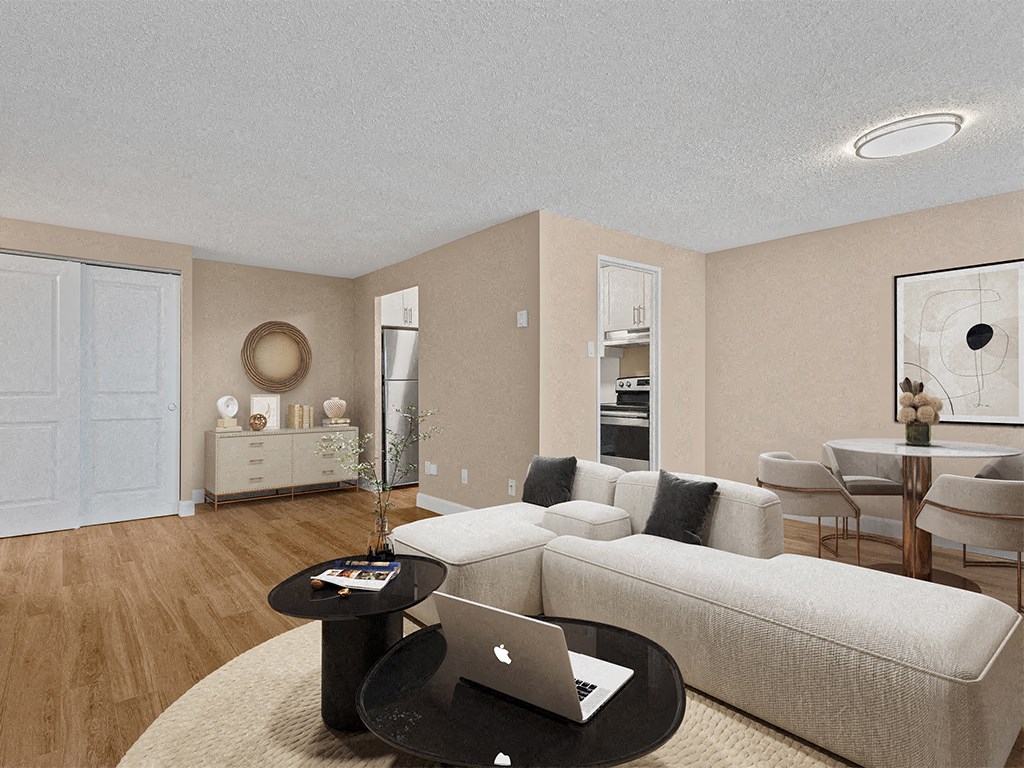 a living room with a couch and a table with a laptop