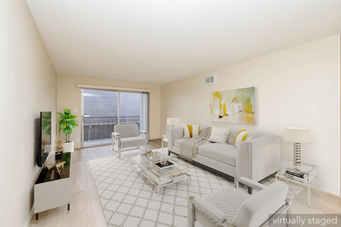 A living room with a white couch and a television.