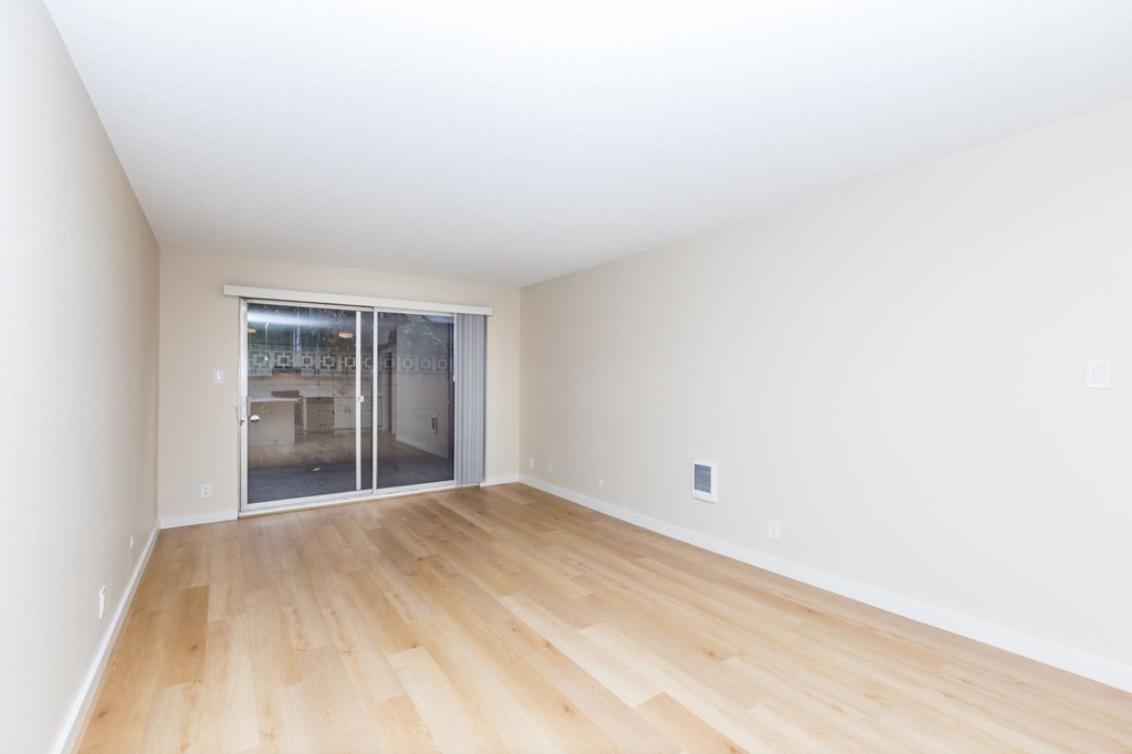 A room with wooden floors and white walls.