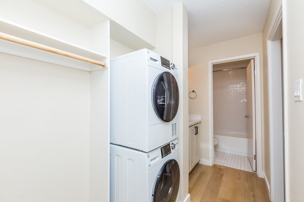 A white dryer and washer in a small laundry room.