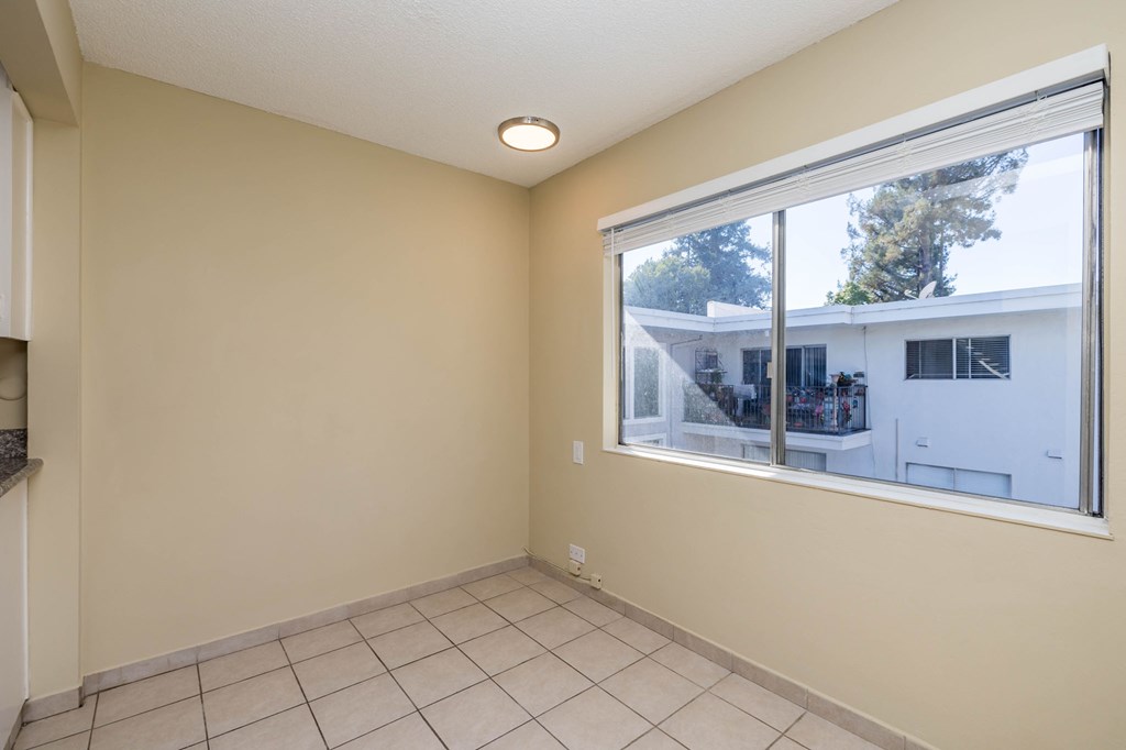 A room with a large window and tiled floor.