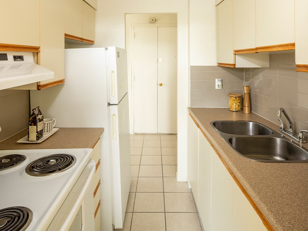 a kitchen with a sink and a stove and a refrigerator