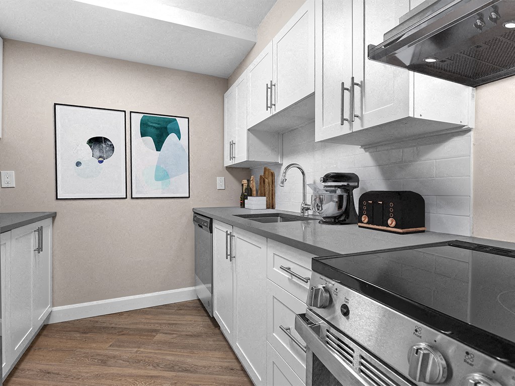 a kitchen with white cabinets and stainless steel appliances and a stove