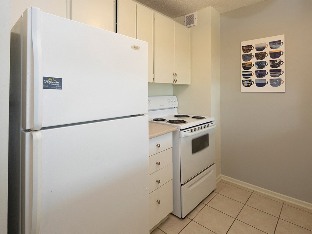 a kitchen with white appliances and a refrigerator