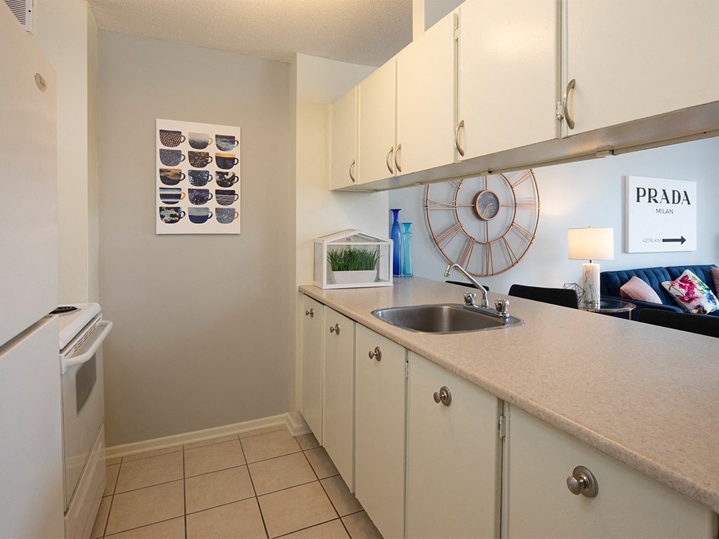 a kitchen with a sink and cabinets and a washing machine